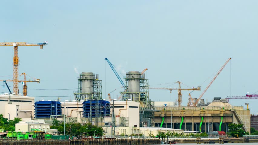 4K:Time-lapse: Crane building site. Power Plant Construction. Dolly shot