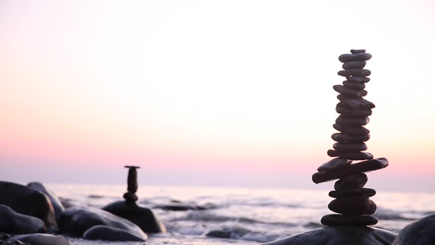 Stone tower on the sea coast on a sunset. Balance and patience  | Shutterstock HD Video #1014401705