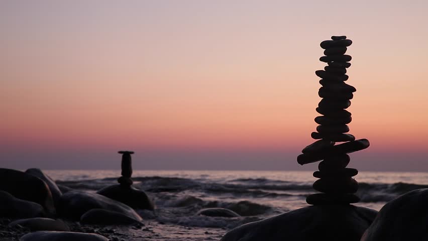 Stone tower on the sea coast on a sunset. Balance and patience  | Shutterstock HD Video #1014401711