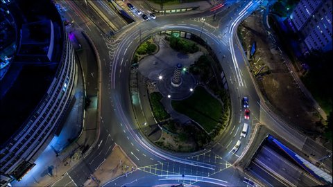 Birmingham, England. Time Lapse of a traffic roundabout at night. Camera zooms in.