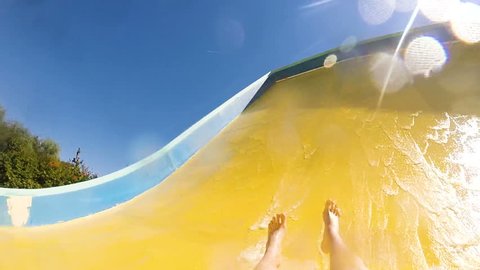 descending down on water slide in water park, first person view