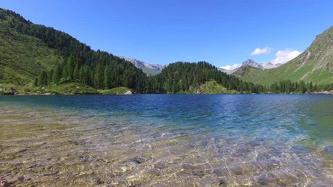 Alpine lake in mountain, beautiful lake and forest. Engadine, Switzerland