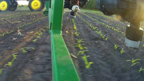 A view of the spray nozzle while working in the field. Sprayer nozzle in operation, tractor sprayer works in the field.