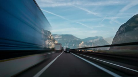 Time Lapse Driver POV motion blur forward driving in Italy countryside road in Dolomite area highway through mountains and valley nature scenic.