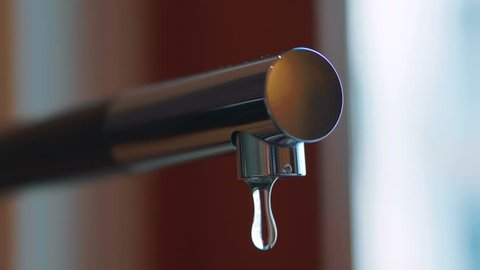 Professional video of water dripping from the tap in 4k slow motion 60fps
