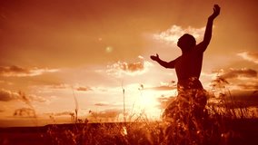 woman praying on her knees. Girl folded her hands in prayer silhouette at sunset. slow motion video. lifestyle Girl folded her hands in prayer pray to God. the girl praying asks forgiveness for sins