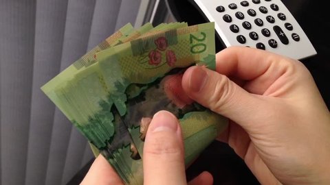 People counting the Canadian twenty dollar bills