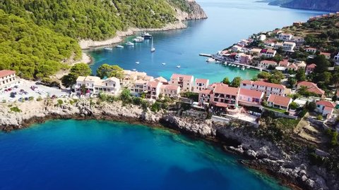 Aerial drone bird's eye view video of beautiful and picturesque colorful traditional fishing village of Assos in island of Cefalonia, Ionian, Greece