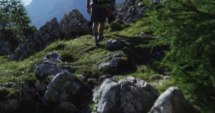 Four friends walking along hiking trail path. Group of friends people summer adventure journey in mountain nature outdoors. Travel exploring Alps, Dolomites, Italy. 4k slow motion 60p video