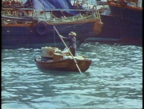HONG KONG, CHINA, 1982, Aberdeen, floating city, boat people, old woman oars POV