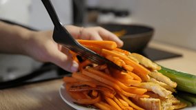 frying carrot, putting in plate, closeup moving shot