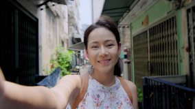 Close up pov of Asian woman's face, using smart phone, recording selfie, wile talking on smartphone in street food market area Bangkok city street Asia. Slow motion real.