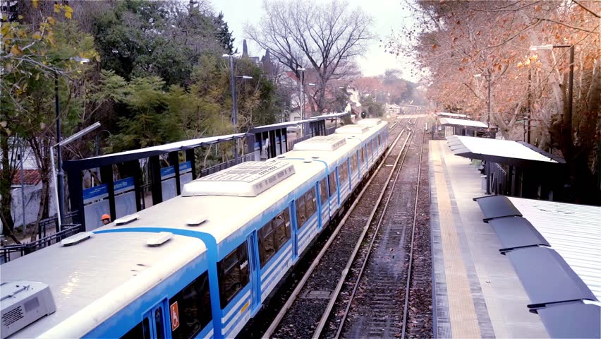 Passenger Train Departing from Lisandro de la Torre Station in Buenos Aires, Argentina - Autumn Day