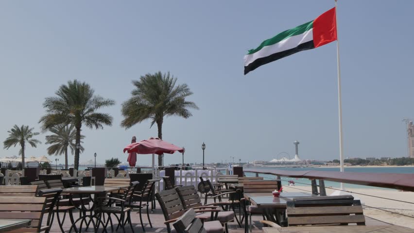 Cafe and UAE flag on the Corniche Road, Abu Dhabi, United Arab Emirates, Middle East, Asia