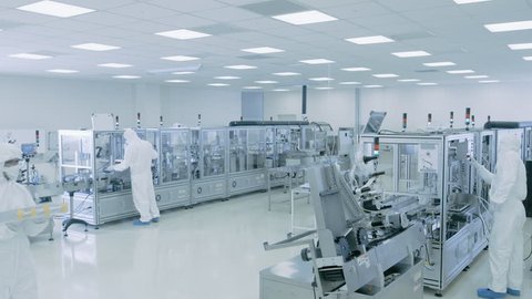Sterile High Precision Manufacturing Laboratory where Scientists in Protective Coverall's Turn on Machninery, Use Computers and Microscopes, doing Pharmaceutics, Biotechnology and Semiconductor Resear