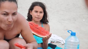 children kids teenagers on the beach resting laughing and eating watermelon slow motion video. girl teenager resting on lifestyle the beach in summer. little girl