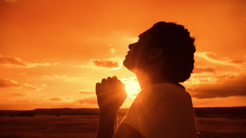 the girl prays. Girl folded her hands in prayer silhouette lifestyle at sunset. slow motion video. Girl folded her hands in prayer pray to God. girl praying asks forgiveness for sins of repentance Royalty-Free Stock Footage #1014484481
