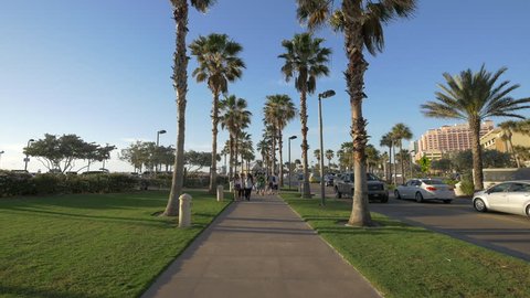 Clearwater, United States - June, 2017: People walking on a park alley