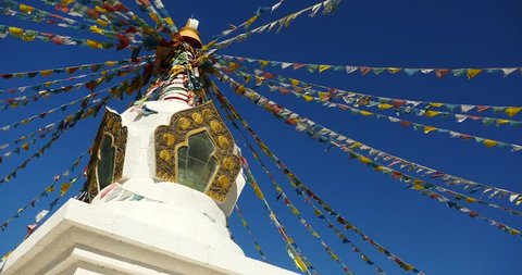 4k buddhist white stupa & flying prayer flags with blue sky background,shangrila yunnan,china. gh2_10505_4k