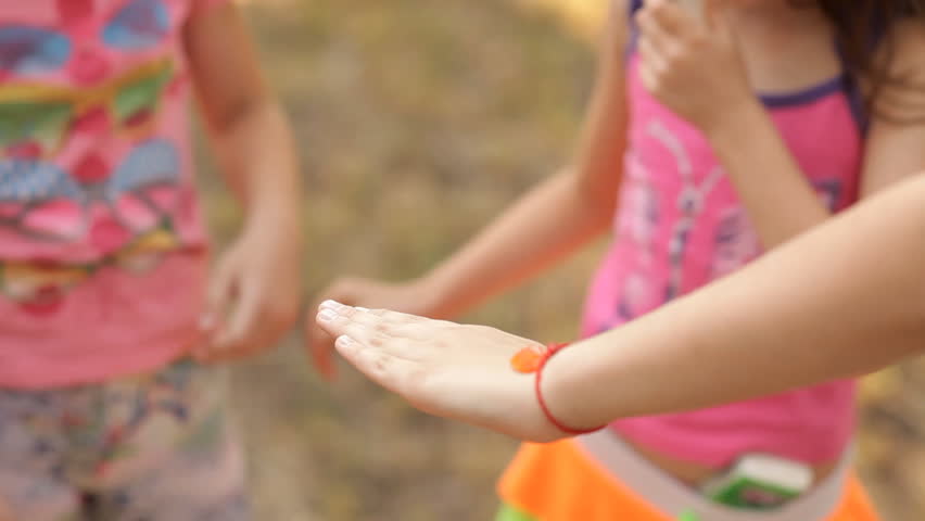 Children have a lot of fun in the summer on the lawn in the park, laugh and play fun.