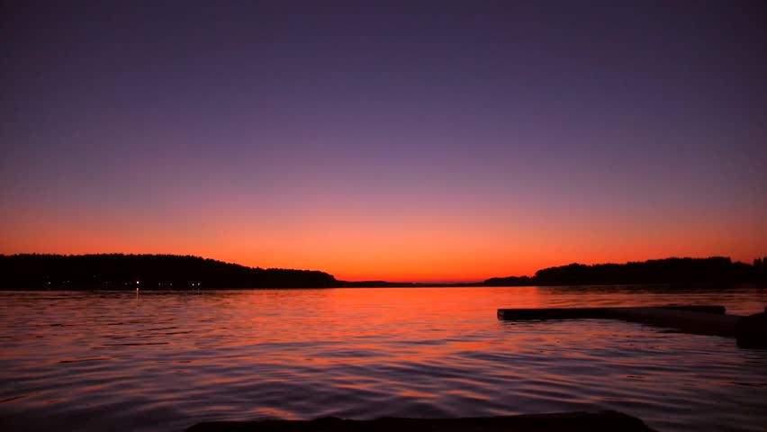 Man Jumping Into the Water from Wooden Pier During Amazing Sunset. Super Slow Motion Cinematic Summer Freedom Lifestyle Footage. HD.