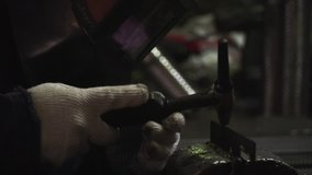 Close-up Welder in protective clothing working with metal, welding metal. Clip. Welding process
