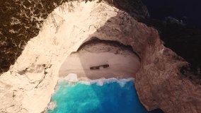 Aerial top view video from iconic Navagio or Shipwreck beach one of the most beautiful in the world with deep turquoise clear sea, as seen from above , Zakynthos island, Ionian, Greece