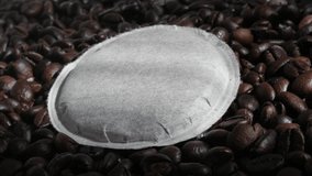 Slow pan over coffee pod on to roasted beans 4K video