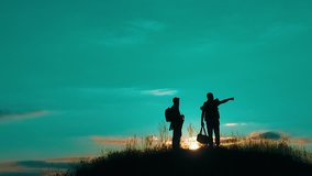 two men tourists night hikers silhouette go to the mountains sunset travel slow motion video. Traveler successful young men walking on top of Mountain and waiting for sunrise. man lifestyle travel