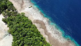 Ungraded clip of overhead aerial view of a beach on an island with clear blue water