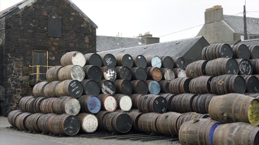Stacks of oak barrels at a scotch whiskey distillery in Campbeltown