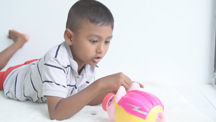 Cute little baby boy save piggy bank