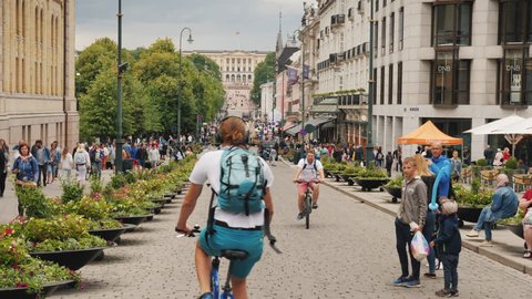 Oslo, Norway, July 2018: Street life in Oslo - A view along the Karl Johans Street towards the Royal Palace. A beautiful and busy street with lots of cafes and shops