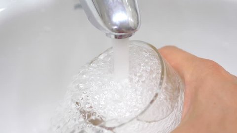 High quality video of water filling glass with clean drinking water in slow motion 180fps
