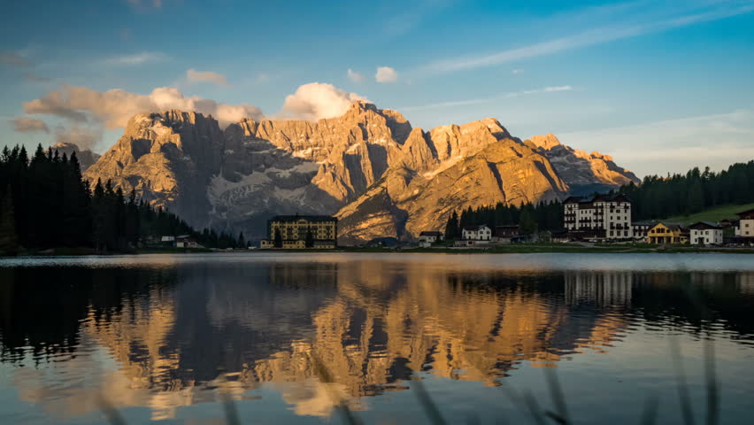 View of the clouds moving on the beautiful Limestone Dolomites Mountain and the famous Lake Misurina in Belluno Province Veneto Region Italy with the reflection on the surface of water