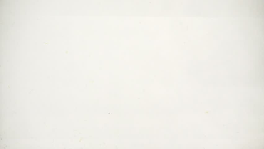 Pineapple slices fall into the water with a plume of bubbles, slow motion close-up