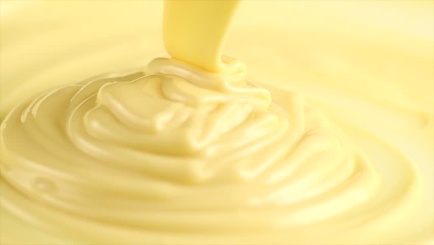 White Chocolate. Pouring melted liquid premium milk white chocolate