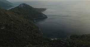 A stunning 4k aerial fly over a luxury catamaran yacht at Paradise Bay and the interesting ancient ruins in Kabak Faralya. Turkey.
