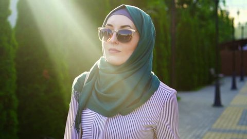 Portrait of a stylish muslim woman in hijab,sunflare.