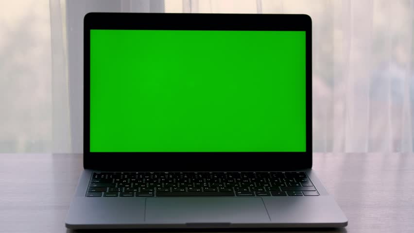 Static laptop computer with a key green screen.  Opposite window. Isolated Royalty-Free Stock Footage #1014596198