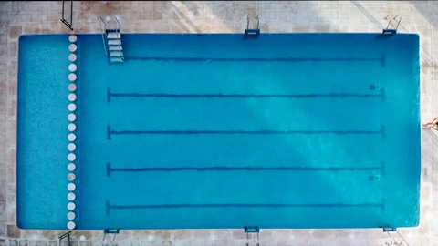 aerial view of a man swimming in a swimming pool