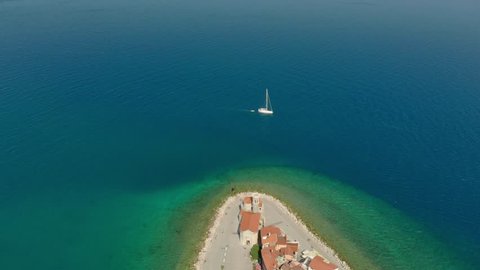 Beautiful aerial footage of Piran town with Tartini main square, ancient buildings with red roofs and Adriatic sea in southwestern Slovenia.