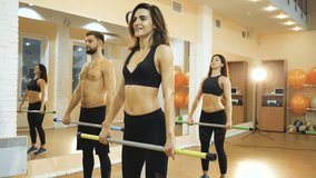 A group of athletes are engaged with a gymnastic stick in the gym