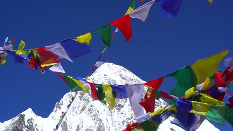 Colorful Nepalese Prayer Flags Fly in Foreground of Himalayas 