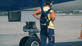 Aircraft maintenance worker inspects just landed airplane - Powered by Shutterstock - Get 15% off with code: PIKWIZARD15