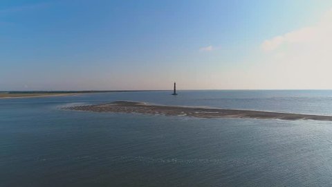 Aerial drone shots of Morris Island Lighthouse at Folly Beach Charleston, South Carolina and the surrounding area.