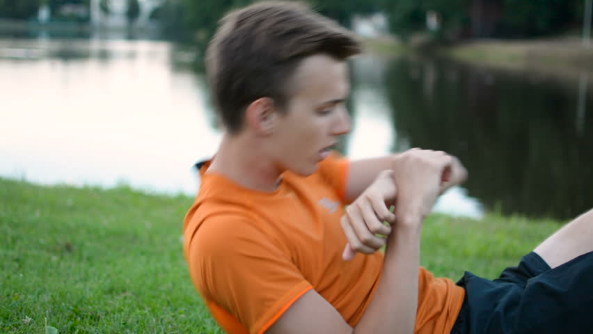 Athletic teenager doing abs criss cross press crunches in outdoor workout