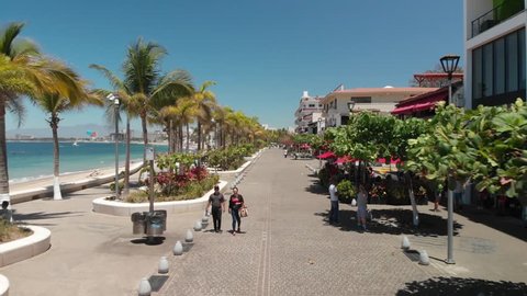 Aerial clip flying over Puerto Vallarta seaside promenade, a 12 mile long walking esplanade in Puerto Vallarta, Mexico.