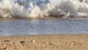 Video footprints in the sand near the sea, women's legs pass along the beach