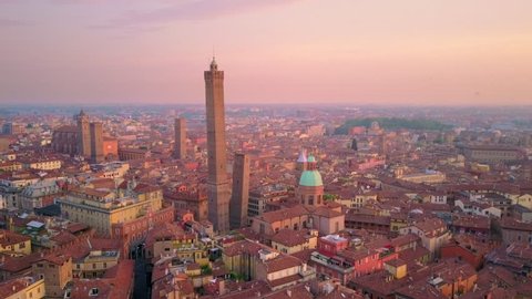 bologna city aerial view at sunrise flying backwards from two towers